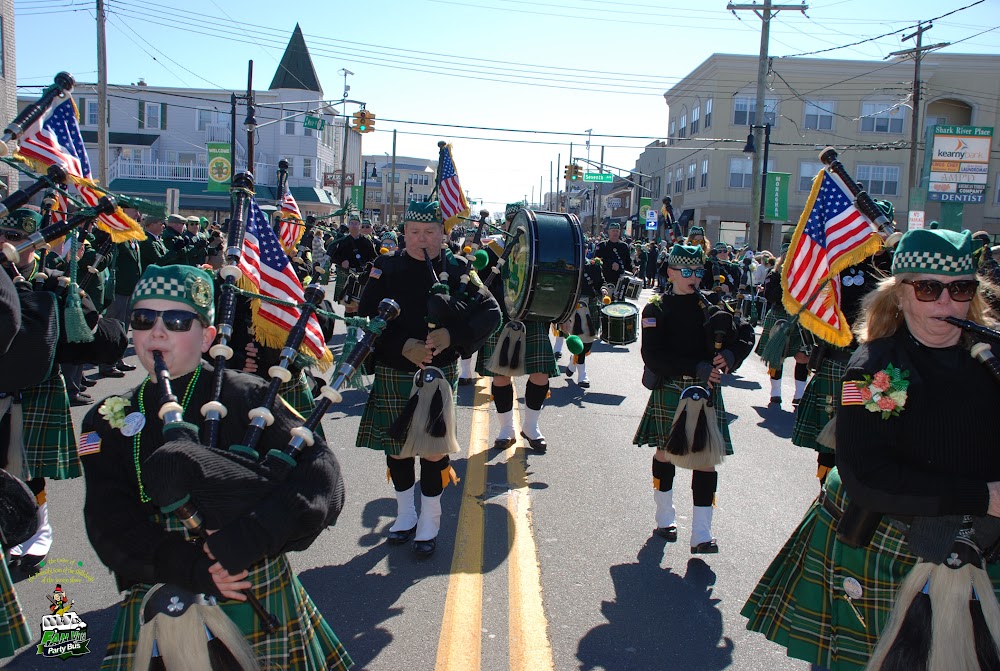 Pipers and drummers carrying American flags during a parade